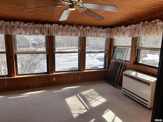 unfurnished sunroom with heating unit, wood ceiling, and ceiling fan