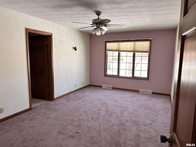 unfurnished room with baseboards, visible vents, and light colored carpet