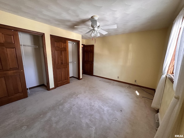 unfurnished bedroom featuring baseboards, a ceiling fan, and light colored carpet