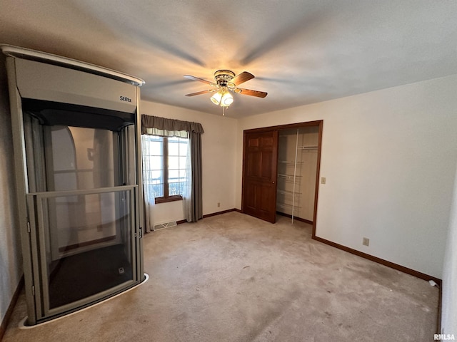 unfurnished bedroom featuring visible vents, a closet, light colored carpet, and baseboards