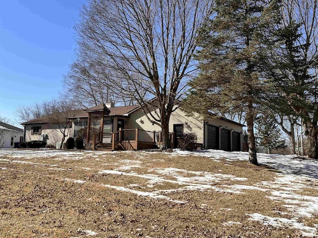 exterior space with a garage and a chimney