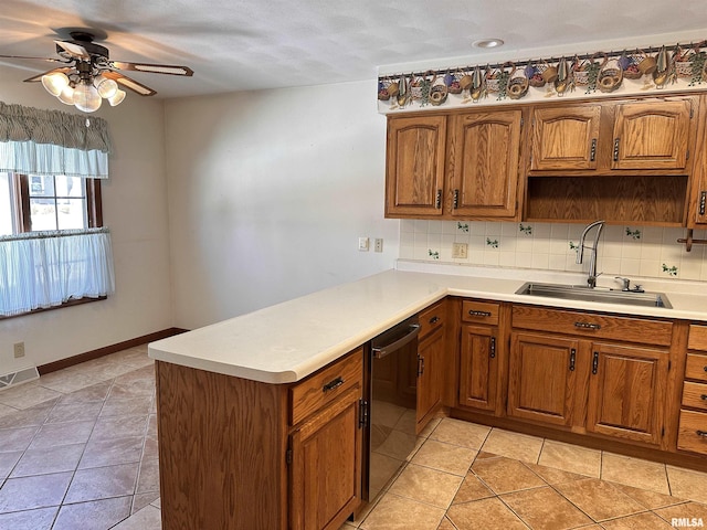 kitchen with black dishwasher, light countertops, a sink, and visible vents