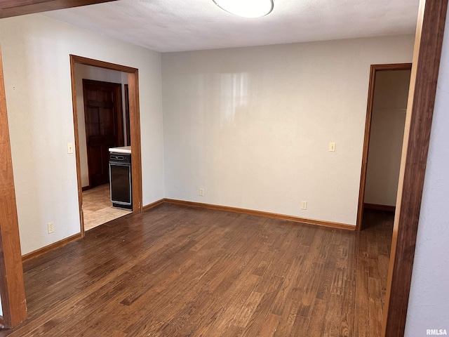 unfurnished room featuring light wood finished floors and baseboards