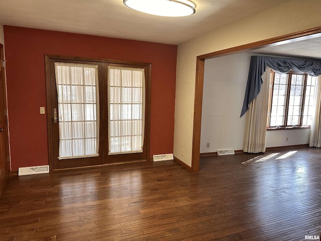 entryway featuring dark wood-style floors and visible vents