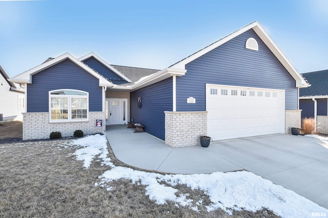 ranch-style house with a garage, concrete driveway, and stone siding