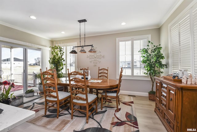 dining space with light wood-style flooring, ornamental molding, baseboards, and recessed lighting