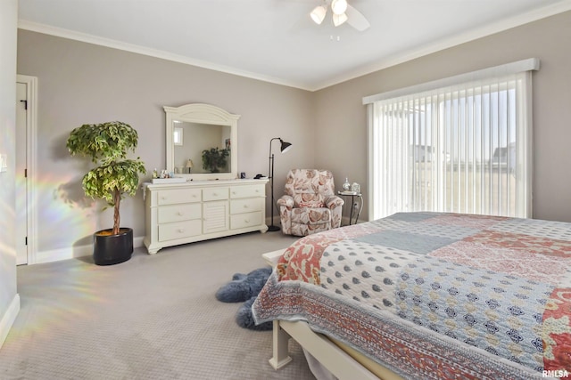 bedroom with carpet floors, crown molding, baseboards, and a ceiling fan