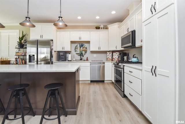 kitchen featuring white cabinets, appliances with stainless steel finishes, and light countertops