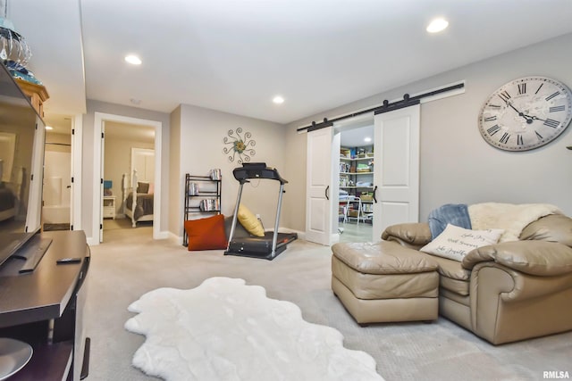 exercise area featuring recessed lighting, light carpet, baseboards, and a barn door