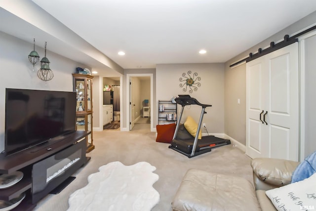 exercise room featuring carpet floors, recessed lighting, baseboards, and a barn door