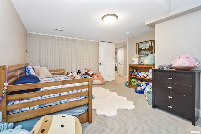 bedroom featuring visible vents and light colored carpet