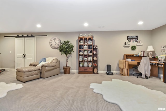 interior space featuring recessed lighting, light carpet, baseboards, and a barn door