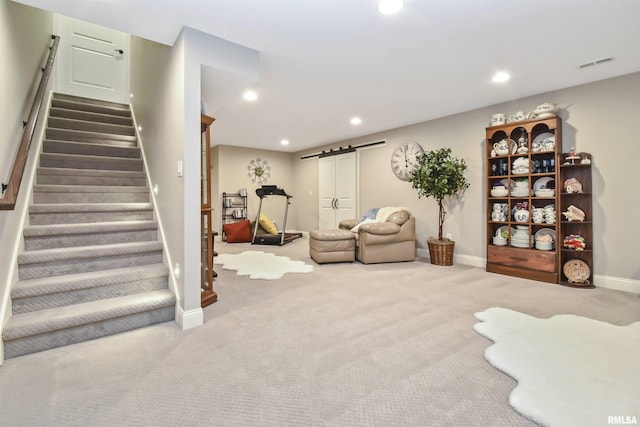 living room with stairway, a barn door, visible vents, and recessed lighting