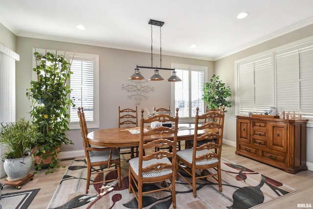 dining room with light wood-style floors, baseboards, crown molding, and recessed lighting