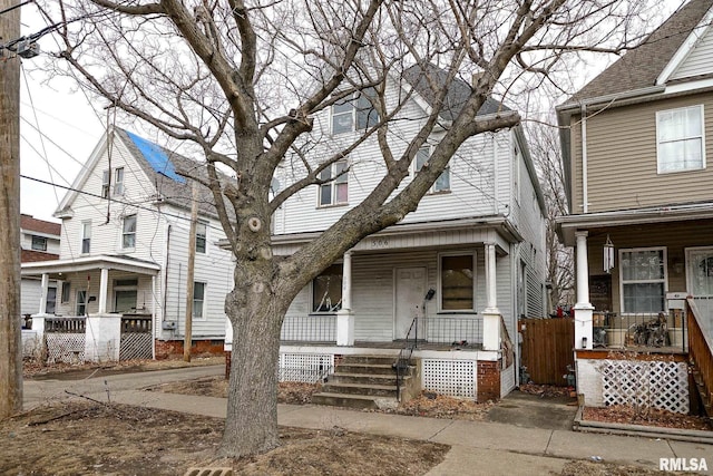 view of front of home featuring fence and a porch