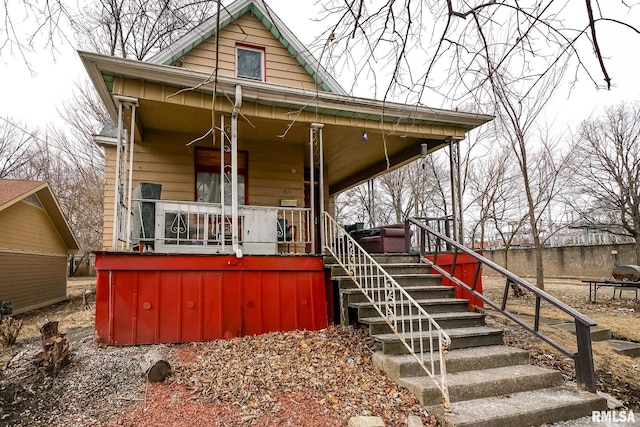 view of front of property with stairs and a porch