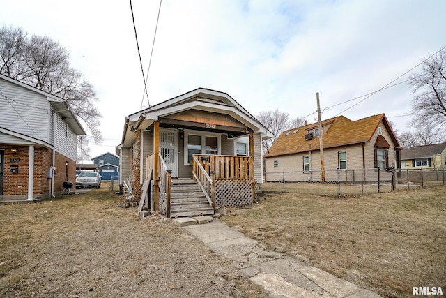 view of front facade featuring covered porch and fence