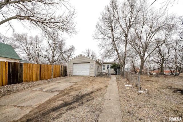 view of front of home with concrete driveway, an attached garage, and fence