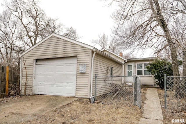 view of front of home with a garage, a chimney, fence, and concrete driveway