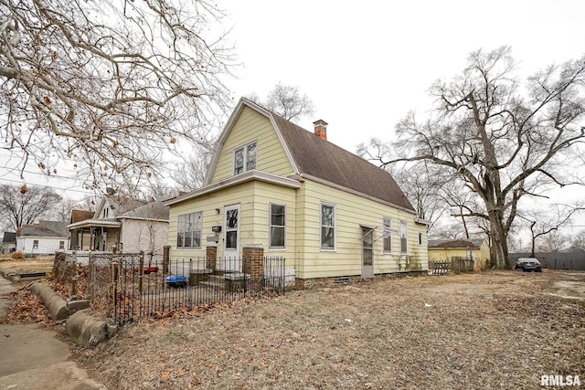 view of front of property featuring a shingled roof, fence, a chimney, and a gambrel roof