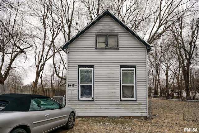 view of side of property featuring fence