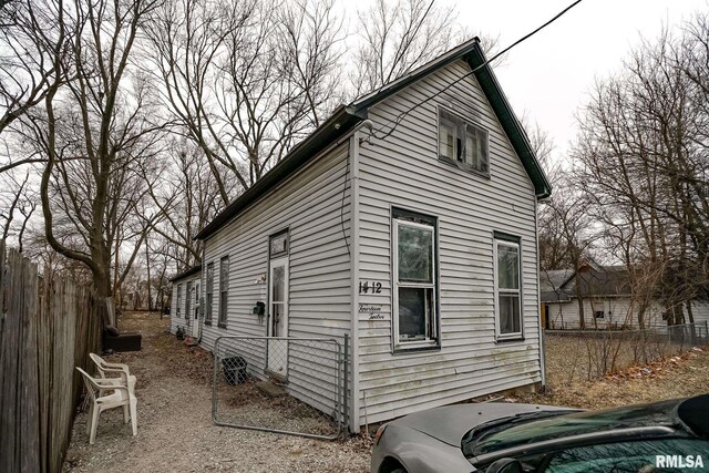 view of side of property featuring fence