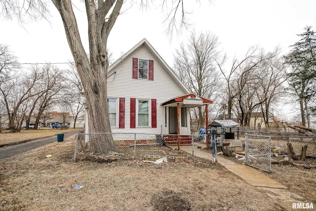 view of front of house with a fenced front yard and a gate