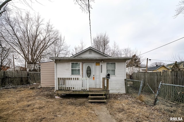 bungalow-style home with fence