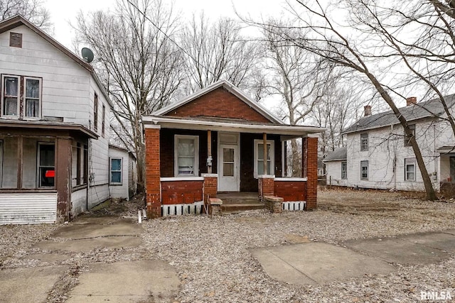 view of front of property featuring a porch and brick siding