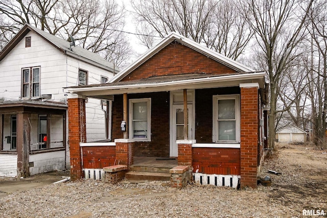 view of front of property featuring a porch and brick siding