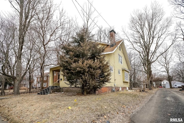 view of home's exterior featuring a residential view and a chimney