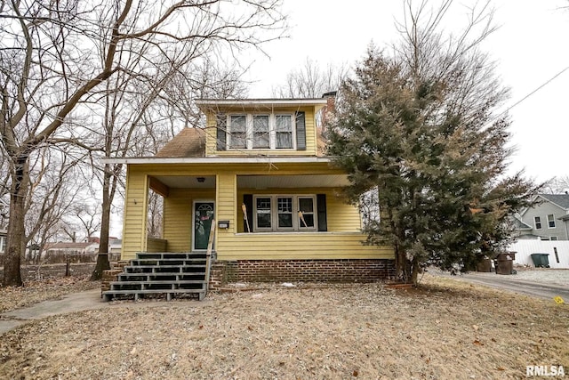 bungalow featuring covered porch and a chimney