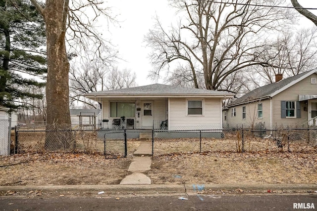 bungalow featuring a fenced front yard, a gate, a porch, and a shingled roof