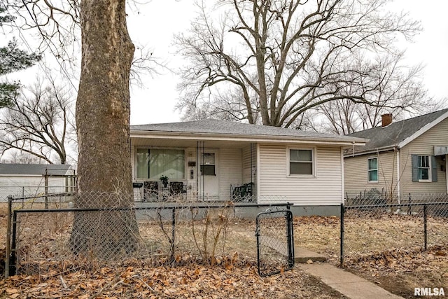 view of front facade with a porch, a fenced front yard, and a gate