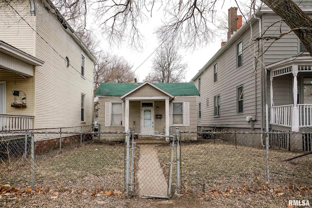 view of yard with a fenced front yard and a gate