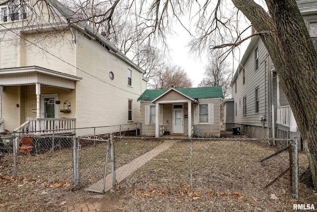 view of property exterior featuring a fenced front yard, a gate, and central air condition unit