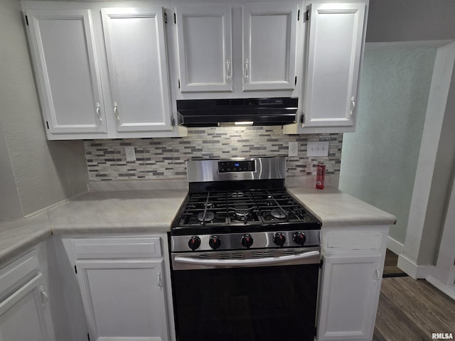 kitchen featuring white cabinets, under cabinet range hood, and stainless steel gas range oven