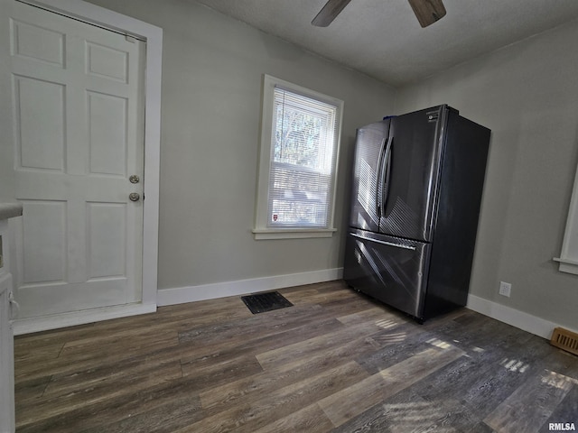 kitchen featuring visible vents, ceiling fan, baseboards, freestanding refrigerator, and dark wood-style flooring