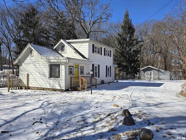 view of front of property with an outbuilding and a storage shed