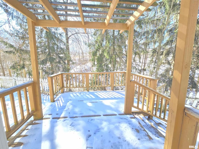 snow covered deck with fence