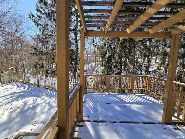 snow covered deck with a pergola and fence