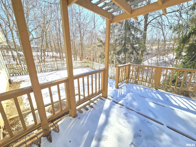 snow covered deck with a pergola and fence