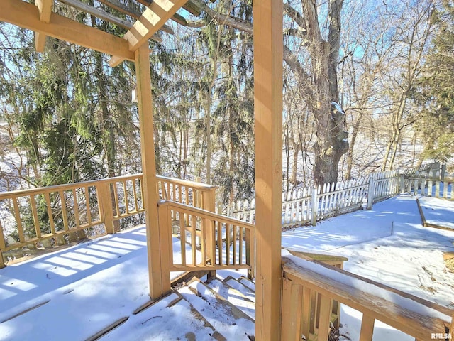 snow covered deck with fence