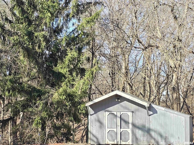 view of shed featuring a wooded view