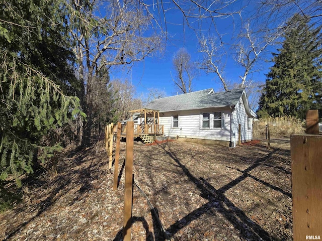 back of house featuring a wooden deck and a pergola