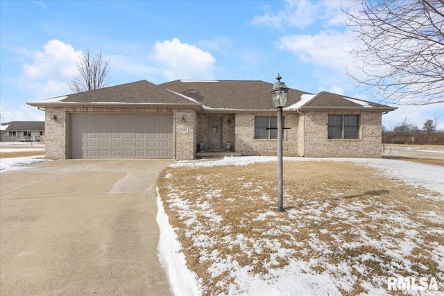 ranch-style home with a garage, a shingled roof, concrete driveway, and brick siding