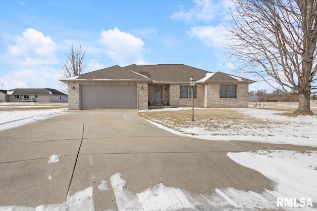 view of front facade featuring brick siding, driveway, and an attached garage