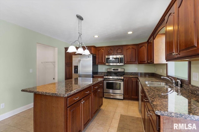 kitchen featuring a kitchen island, appliances with stainless steel finishes, decorative light fixtures, a sink, and light tile patterned flooring