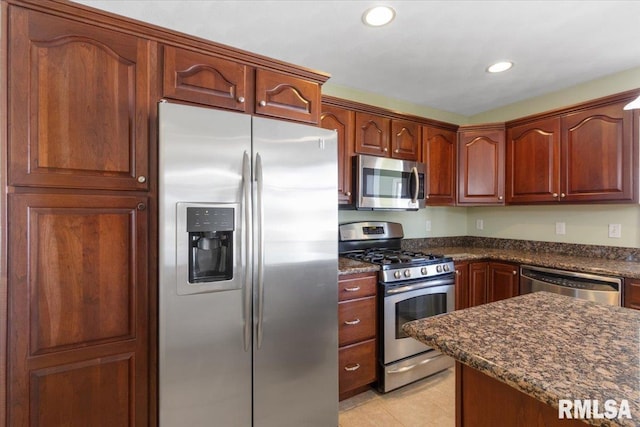 kitchen with stainless steel appliances, dark stone countertops, and recessed lighting