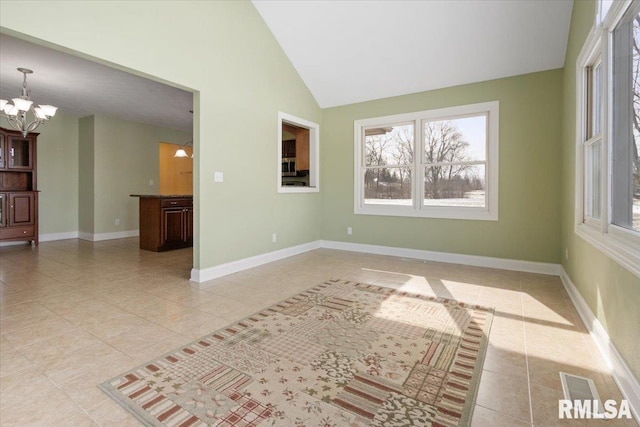 spare room with a chandelier, high vaulted ceiling, light tile patterned flooring, and baseboards